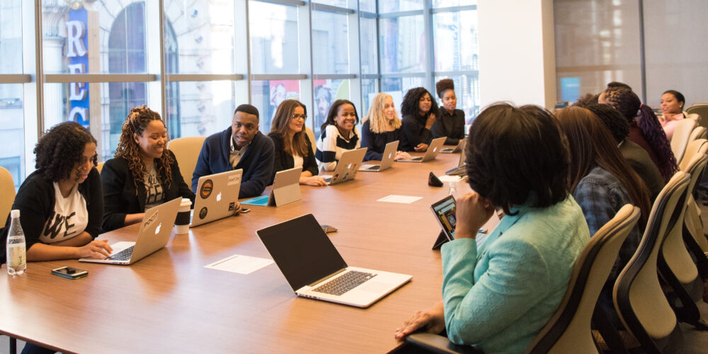 Employee Retention - A diverse team sits around a boardroom table